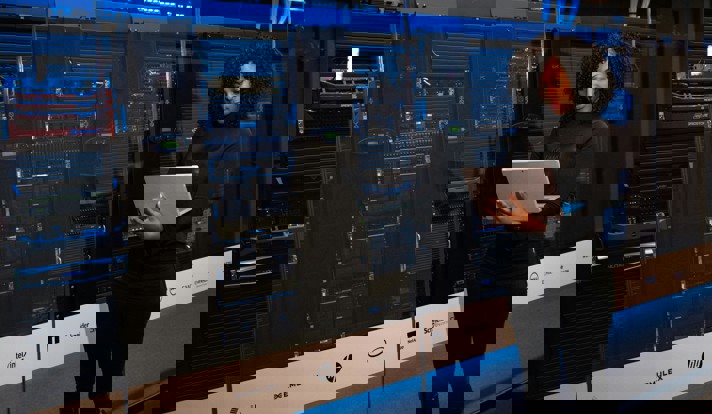 Software Engineer Standing Beside Server Racks