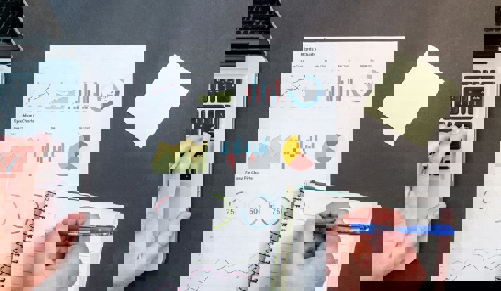 Person Writing On Notebook