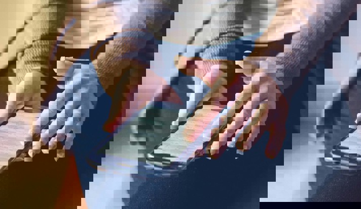 Person Holding Smartphone While Sitting